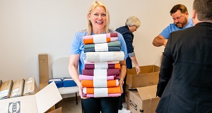Essentia Health’s community relations director Tonya Loken helped unpack housewares at the Brewery Creek Apartments