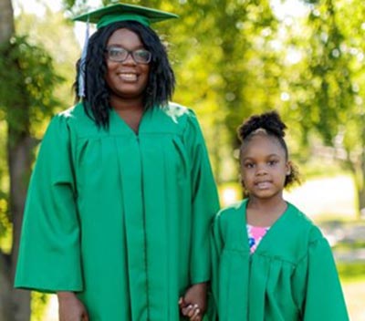 adult and child in graduation gowns