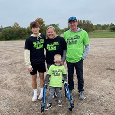 three adults and a child outside smiling for photo