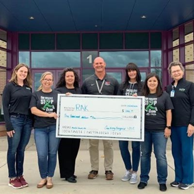 group outside holding giant check
