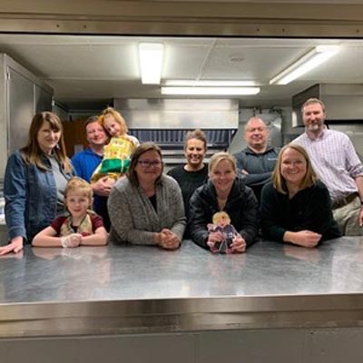 volunteers standing in kitchen