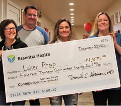 group holding giant check for laker prep