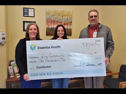group holding oversized check