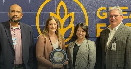 two men and two women holding award