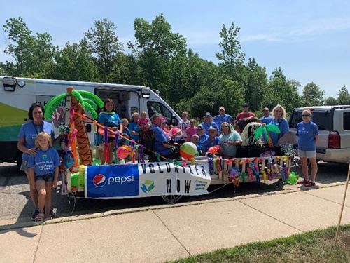 Group in front of ambulance for a parade