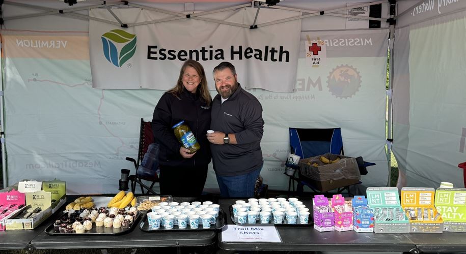 Essentia health volunteers with a spread of snacks and drinks on a table