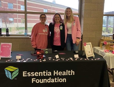 group of three adults in pink