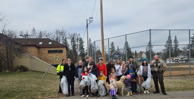 Essentia volunteers holding trash  bags containg trash