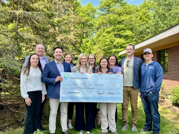 Group of people holding a big check