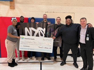 a group holding a big check